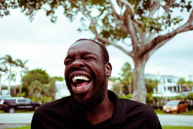 A man laughing big